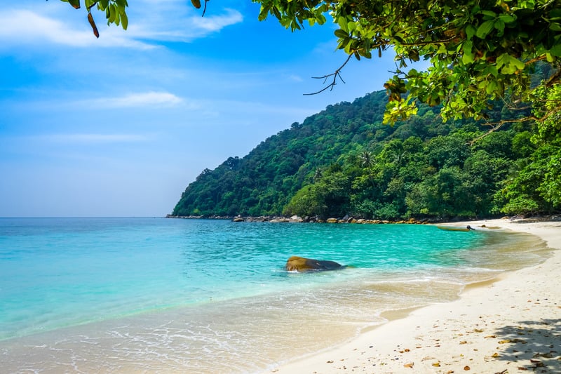 Turtle Beach on the Perhentian Islands, Malaysia, showing white sand and turquoise water.